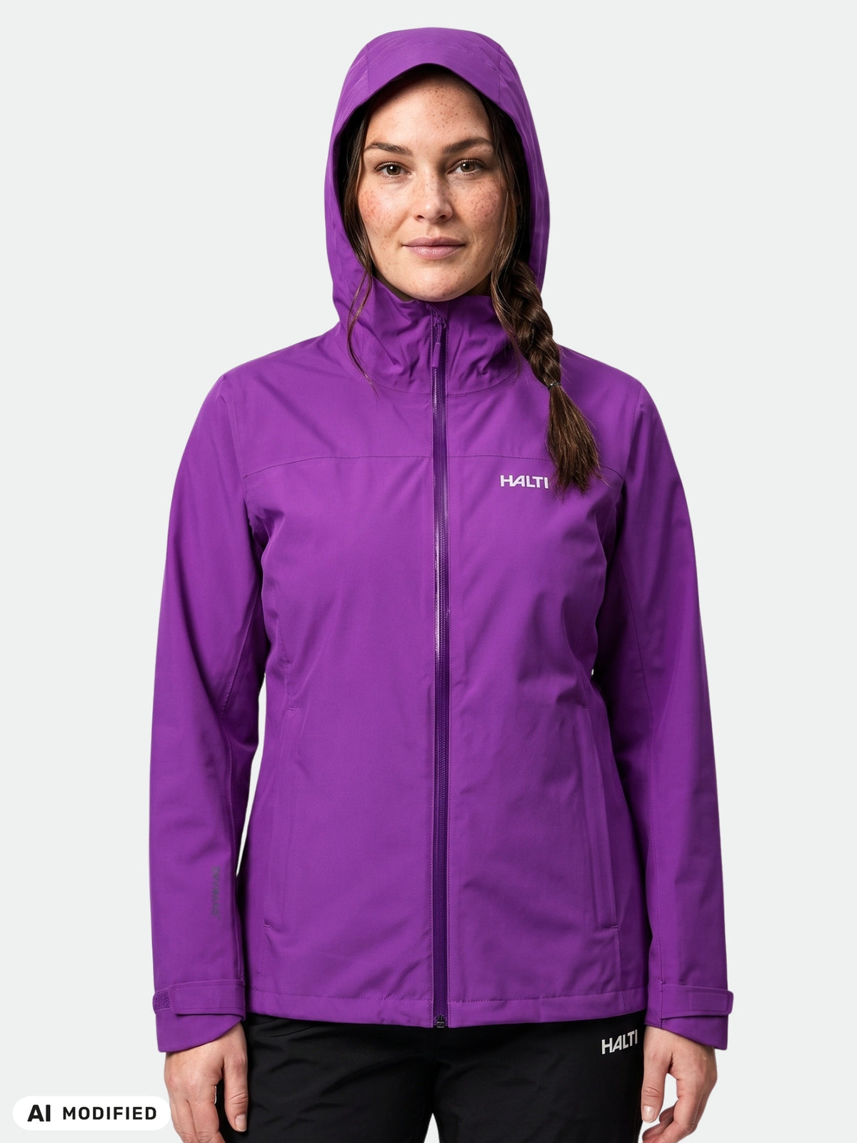 A braided woman wears a Halti Kaltimo DX Shell Jacket Women’s Plus in purple, against a plain light background.