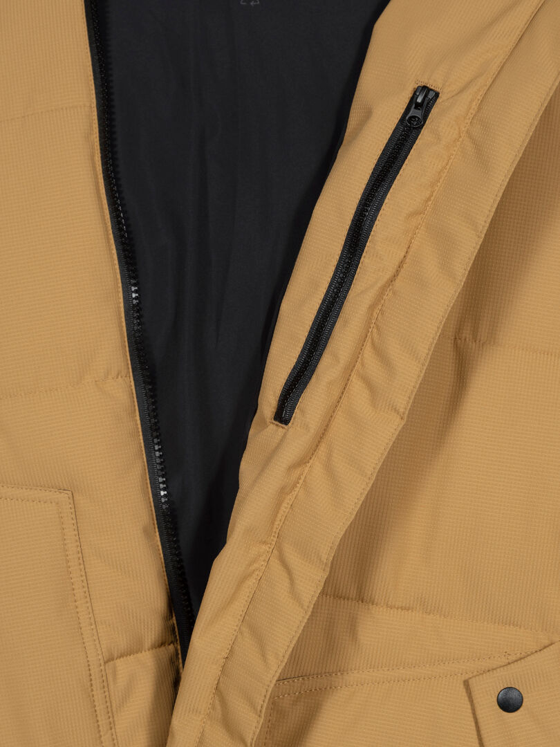 Close-up of the Halti Linjat Parka Jacket Men's in tan with quilted design, inner black zipper pocket, and front zip.