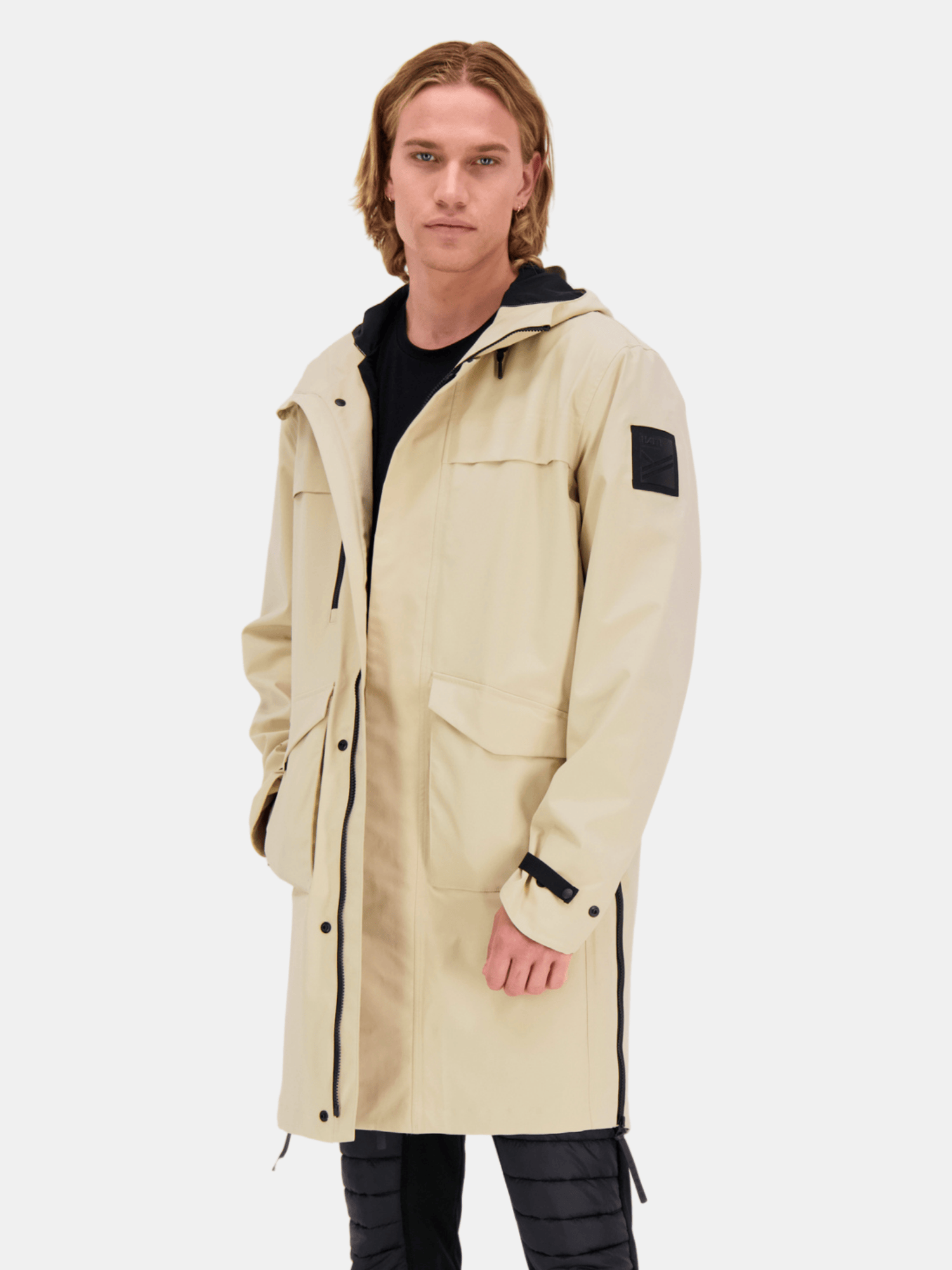A man wears the Halti Tokoi Mens DrymaxX Parka Jacket with black details, standing against a white background.