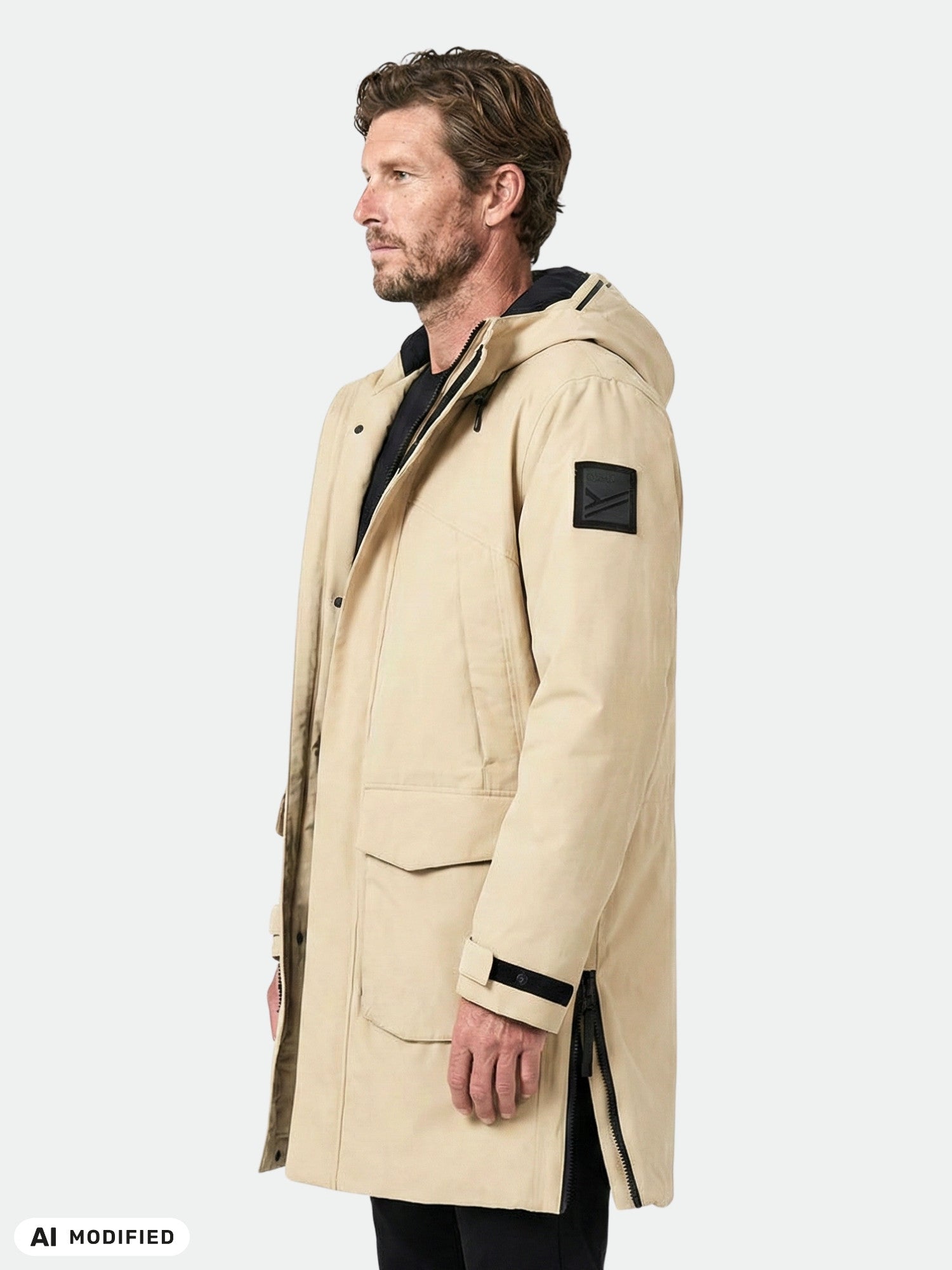 Man in Halti Bergga DX Winter Parka stands sideways, hands at sides, against plain light background.