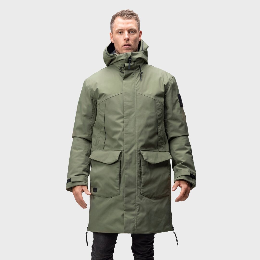 A man wears the Halti Bergga Mens DrymaxX Winter Jacket, standing against a plain light gray background.