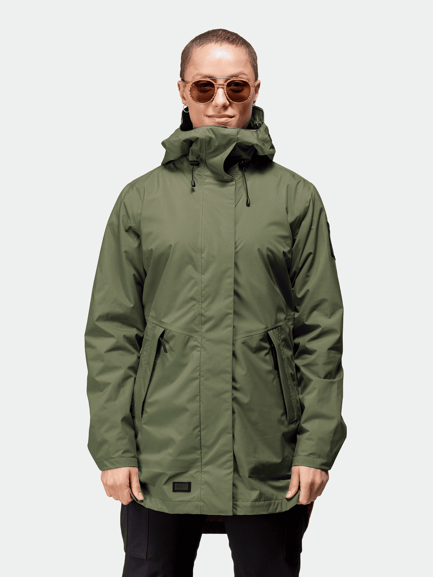 A woman in a Halti Kurvi DrymaxX 3L Parka Jacket faces forward in sunglasses against a plain background.