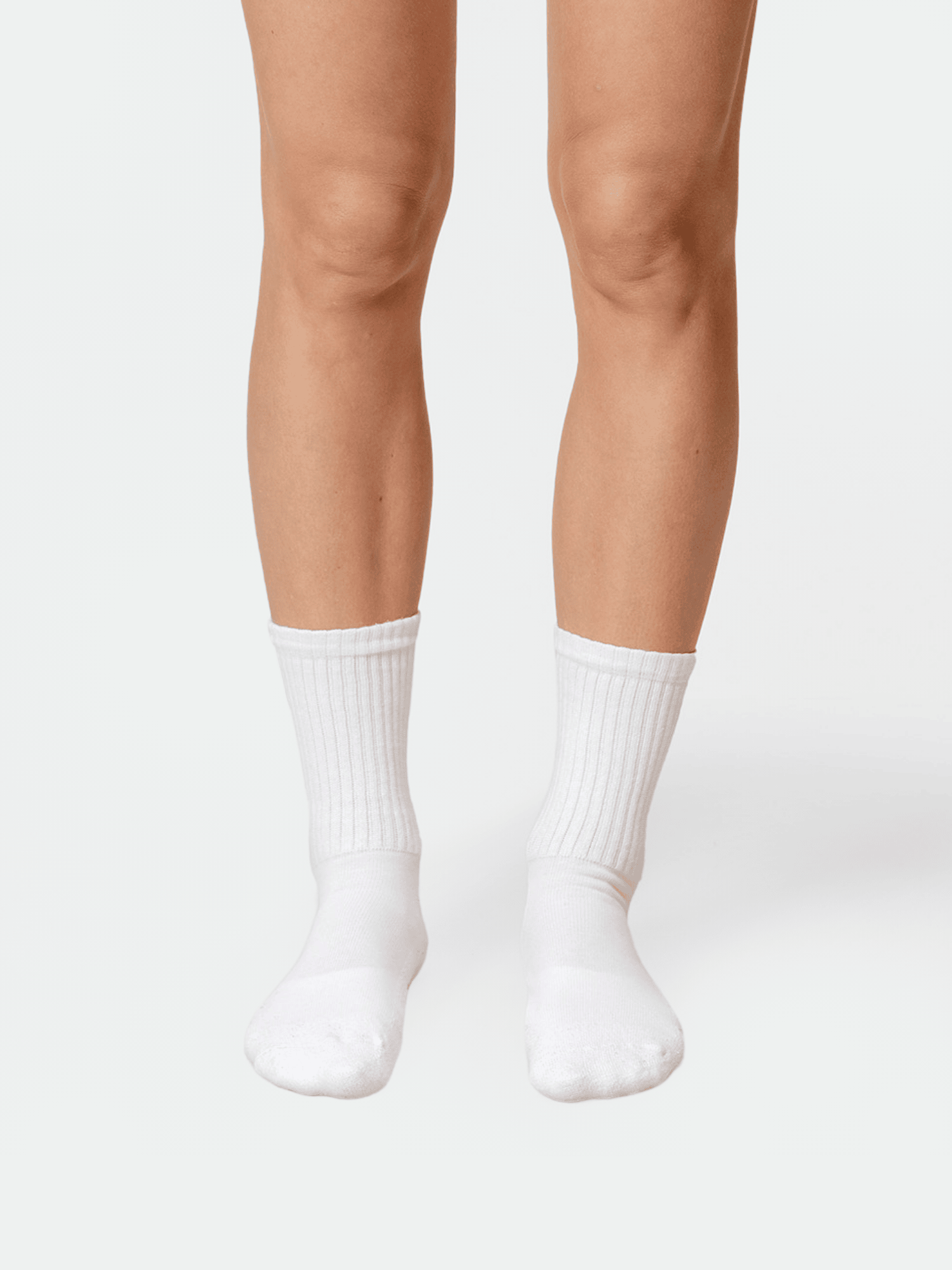 Model wears Halti Kallio Socks; organic cotton crew style, legs visible from mid-thigh down on white background.