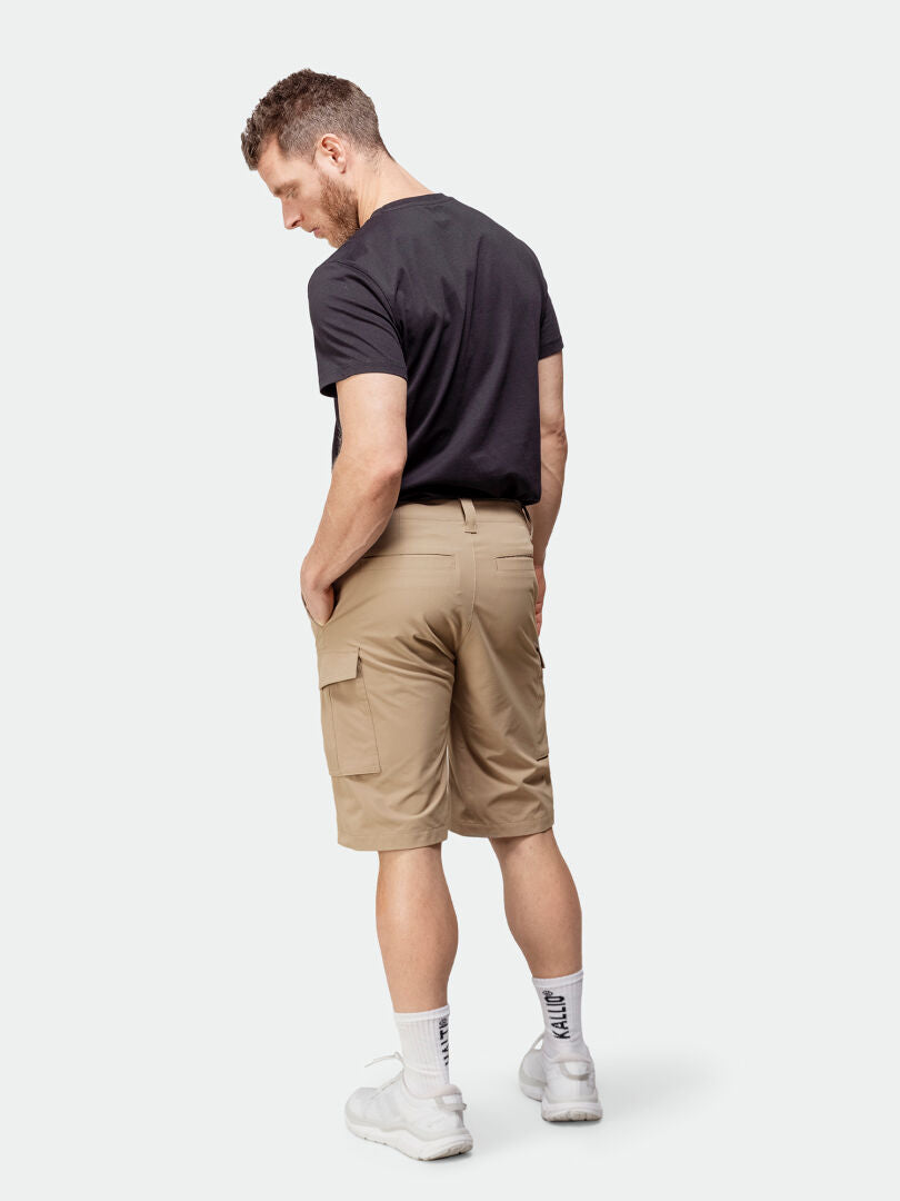 Man faces away, wearing Halti Roams Shorts Mens in stretchy ripstop fabric with a black t-shirt.