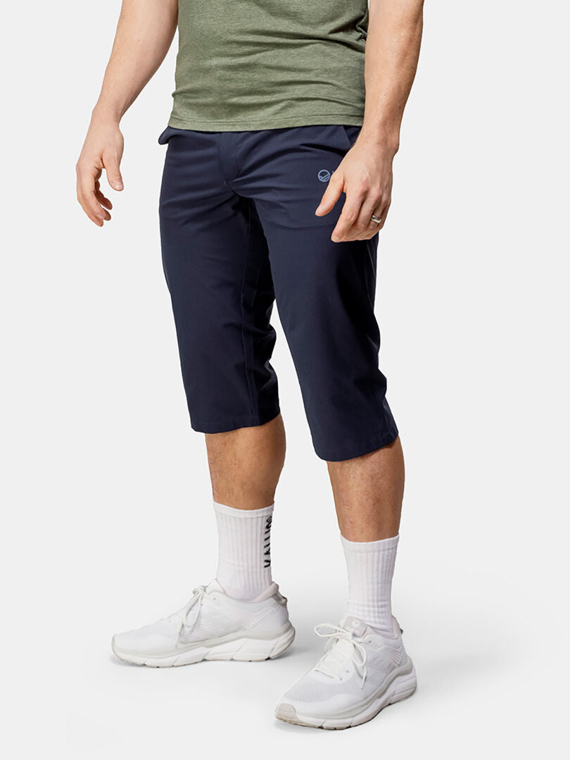 A person in Halti Drive X-stretch Capri Pants stands against a plain background.