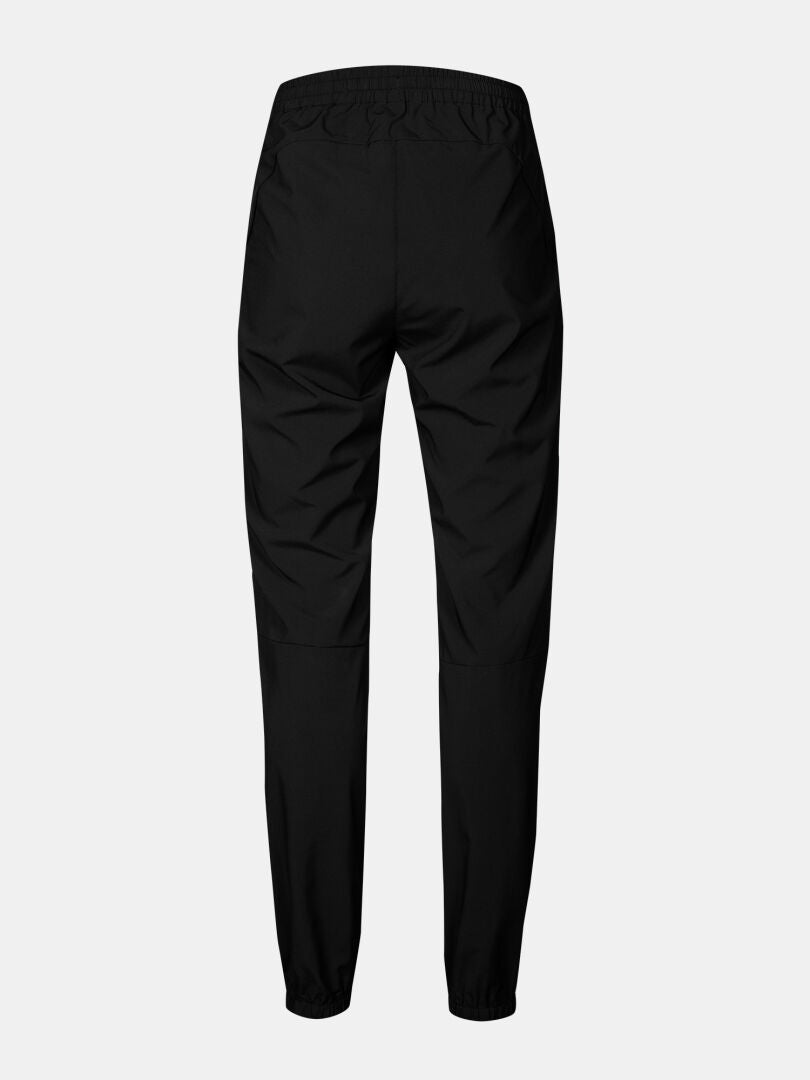 Halti Grets Jogger Pants Women's—black, quick-dry stretch fabric, elastic waist, back view on light background.