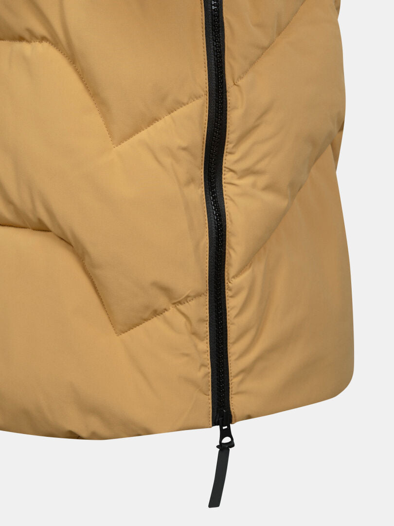 Close-up of Halti Brahe Puffer Long Winter Jacket Women’s in tan, featuring black zipper and diagonal quilting.