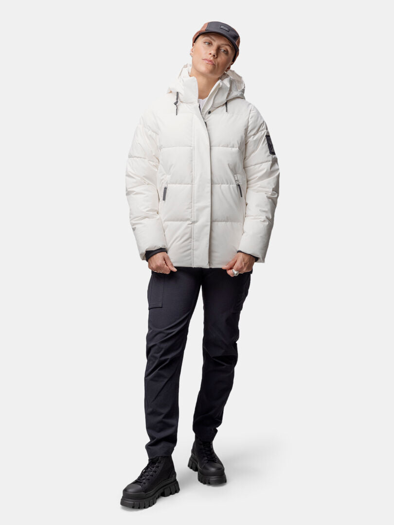 A woman wears the Halti Brahe Puffer Winter Jacket, made from recycled polyester, against a plain background.