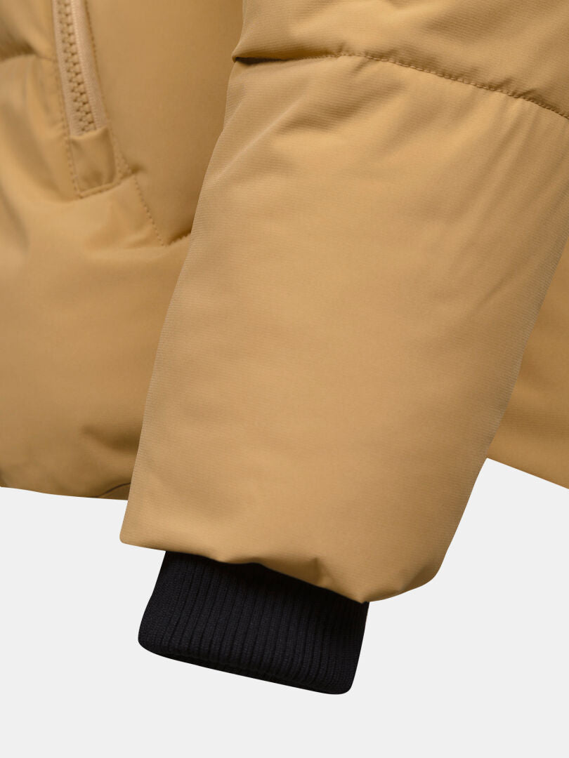Close-up of Halti Brahe Puffer Winter Jacket Women's tan recycled polyester sleeve with black cuff and zippered pocket.