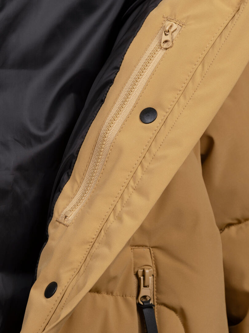 Close-up of Halti Brahe Puffer Winter Jacket Women's with zippered inner pocket, black snap buttons, and black lining.