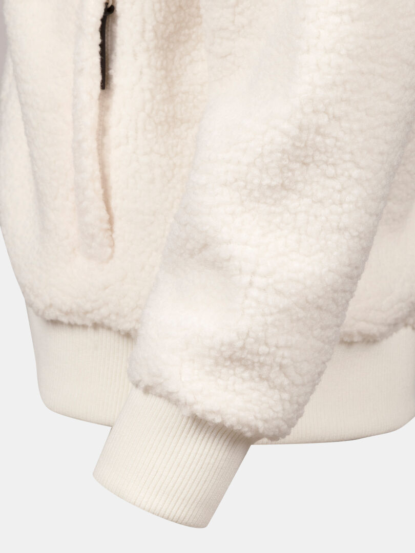 Close-up of the Halti Lykky Fleece Jacket Womens sleeve with ribbed cuff, soft texture, and side pocket.