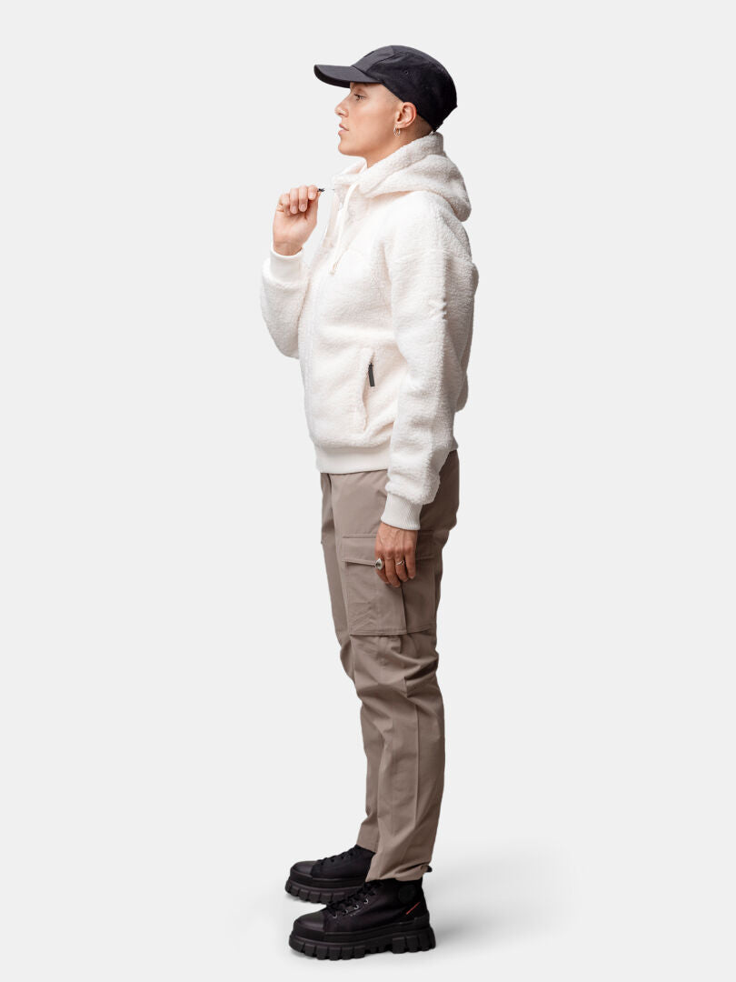 A woman wearing the Halti Lykky Fleece Jacket stands in profile against a plain background.