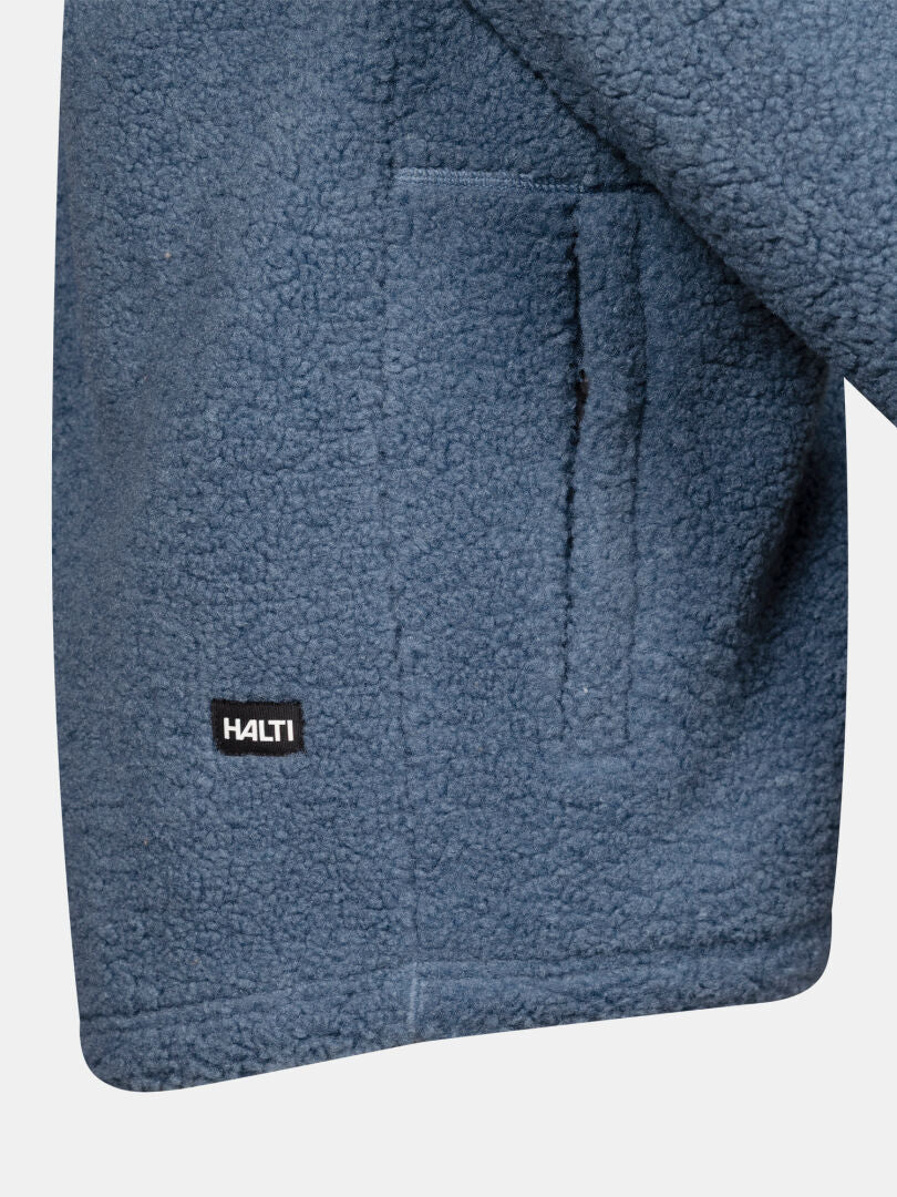 Close-up of the Lykky Fleece Jacket Men’s pocket, showing hoodie-like fleece and black Halti label by the hem.