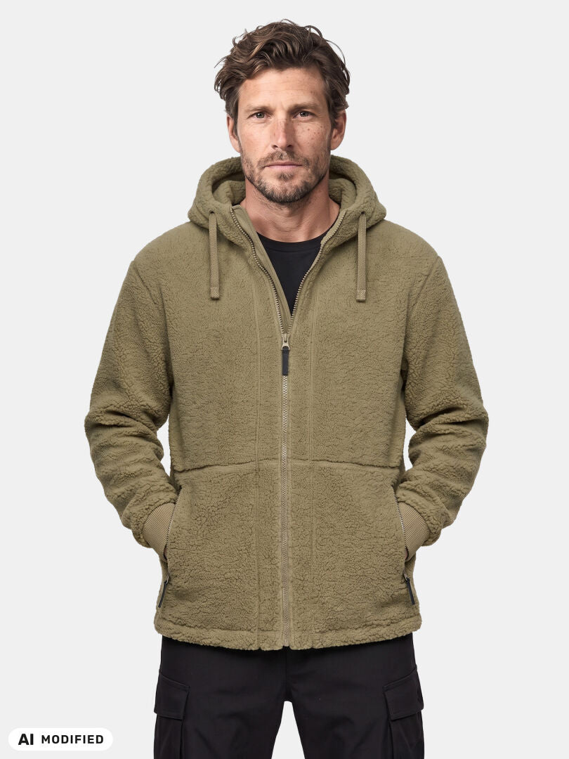 Urban explorer in an olive green Halti Lykky Fleece Jacket Men’s with pockets, against a plain light background.