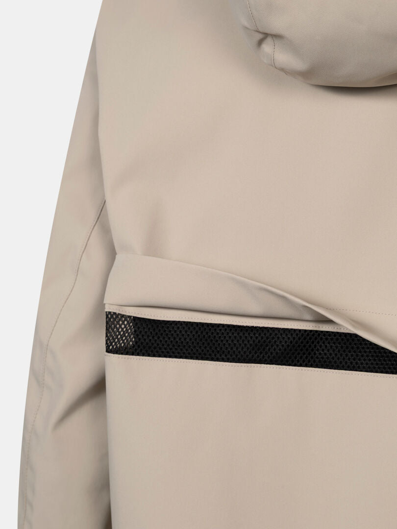 Close-up of the Halti Tokoi DX Jacket Women's in beige, showing black mesh back strip, sleeve, and hood detail.