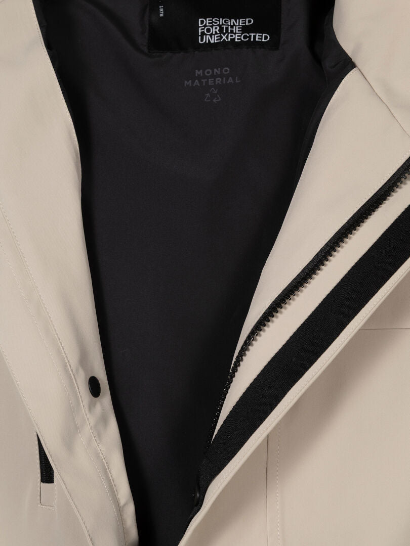 Close-up of Halti Tokoi DX Jacket Men's in beige with black lining, zipper, and