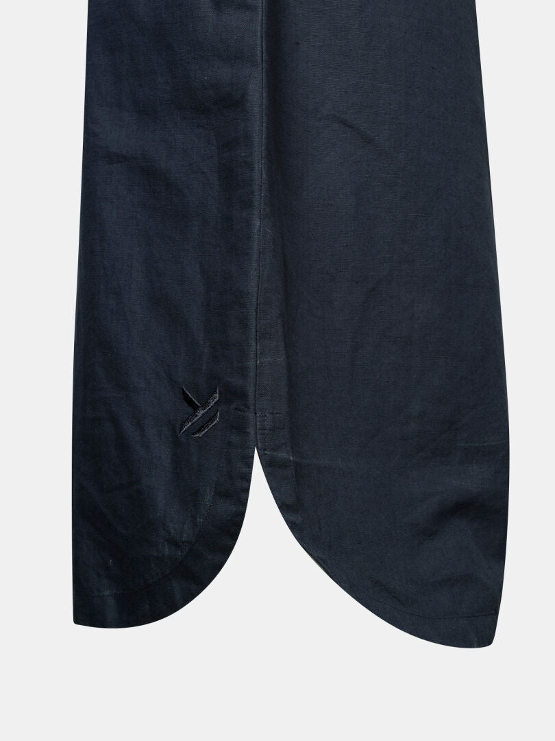 A close-up of the Halti Notsgi Dress Women's dark blue hem, featuring a curved edge and subtle stitched detail.
