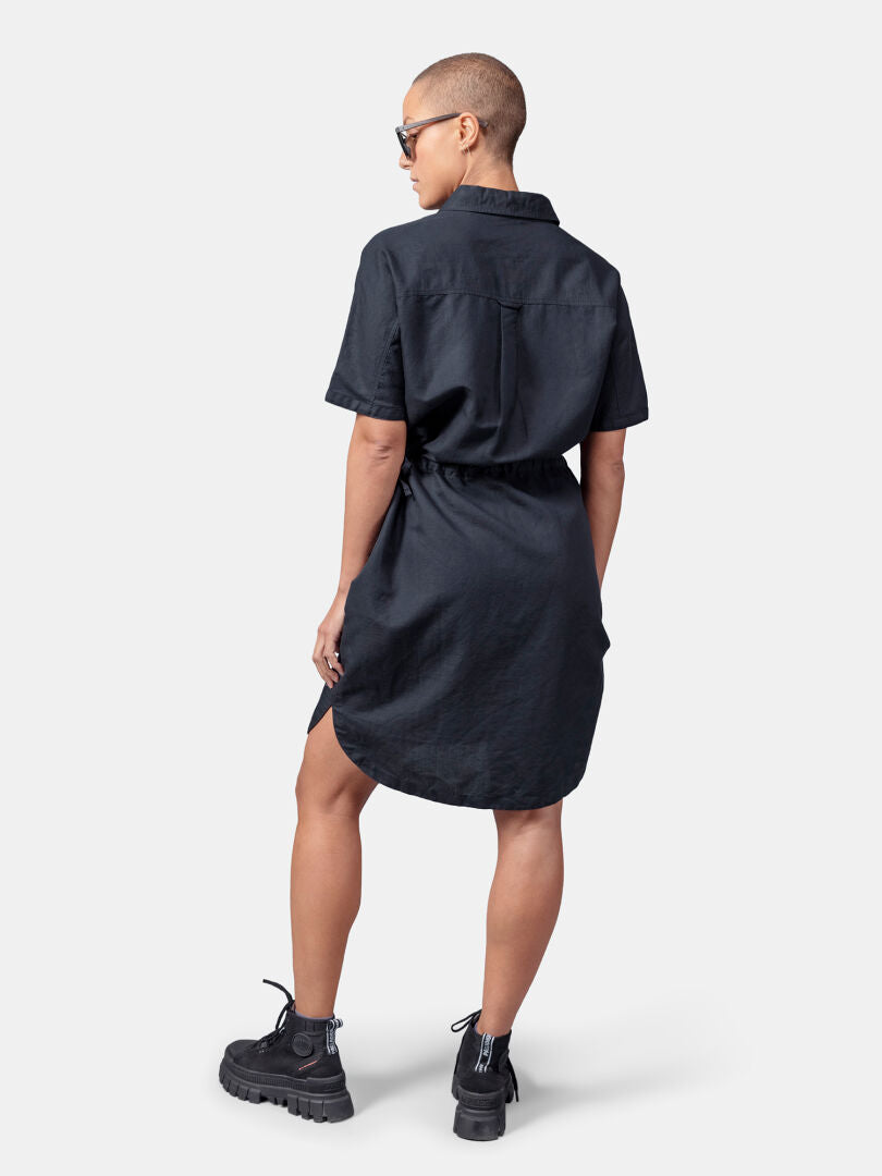 Person stands with their back to the camera, wearing Halti Notsgi Dress Women's and black boots.