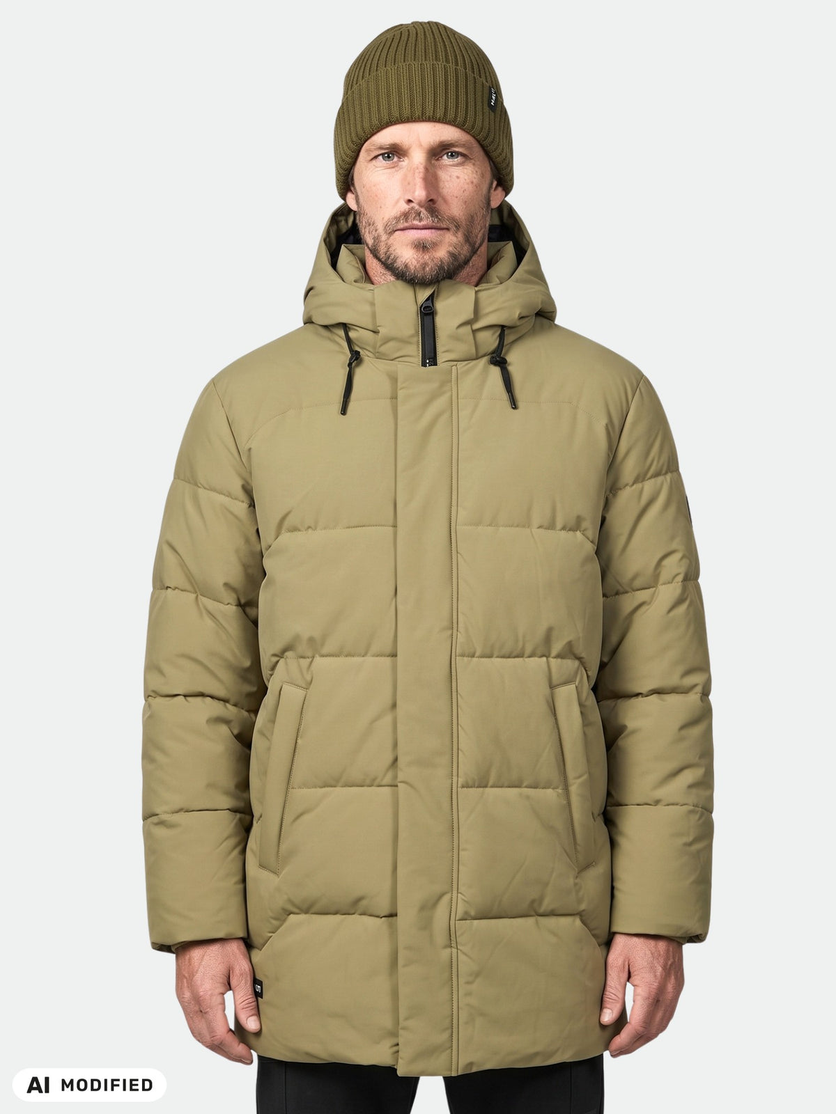 Man wears Halti Brahe Puffer Parka in olive green and a knit beanie, facing forward against a plain light background.