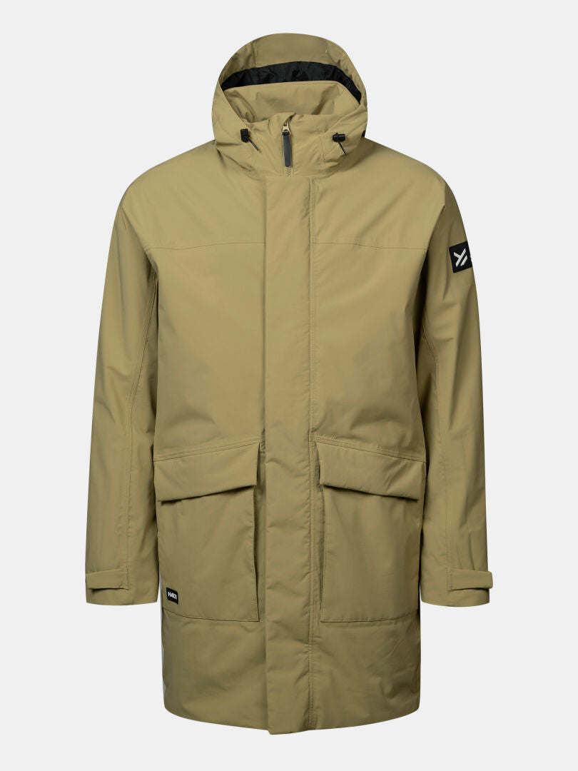 Halti Kortteli DX Men’s Parka: long, khaki, insulated, hooded, front pockets, black logo patch on left sleeve.