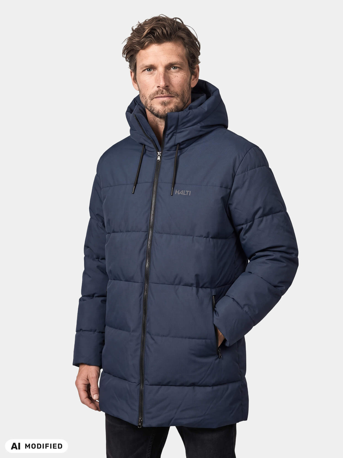 Man wearing a navy blue Halti Kaimoa Insulated Jacket, an insulated hooded parka with a full-length zipper.