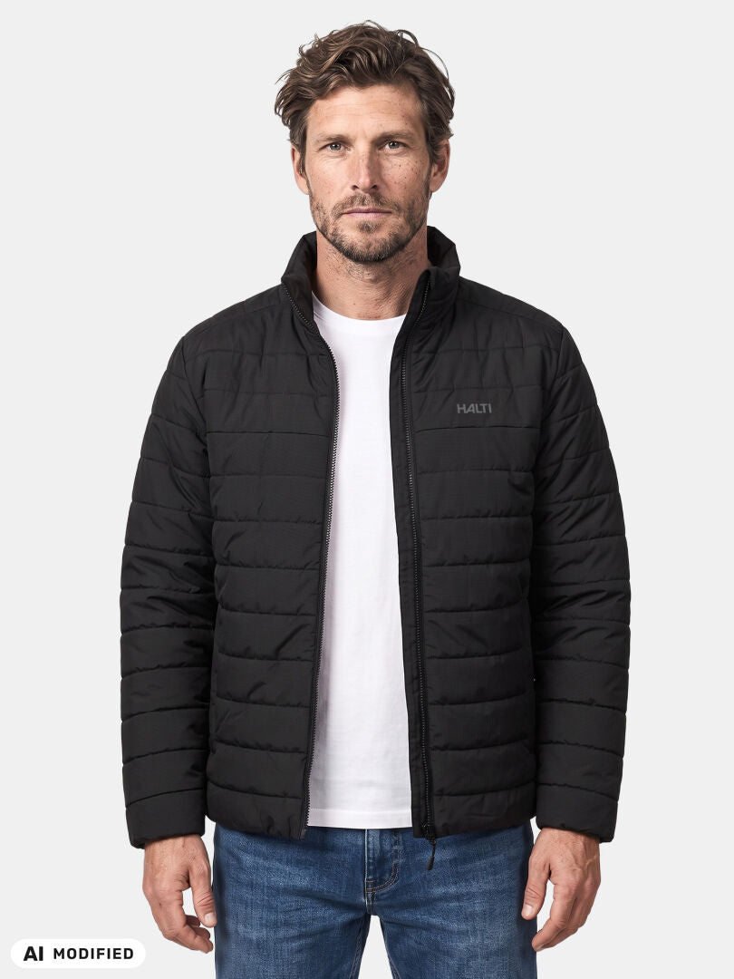 Man wearing Halti Rehia Insulated Jacket over white tee and blue jeans, standing against plain background.