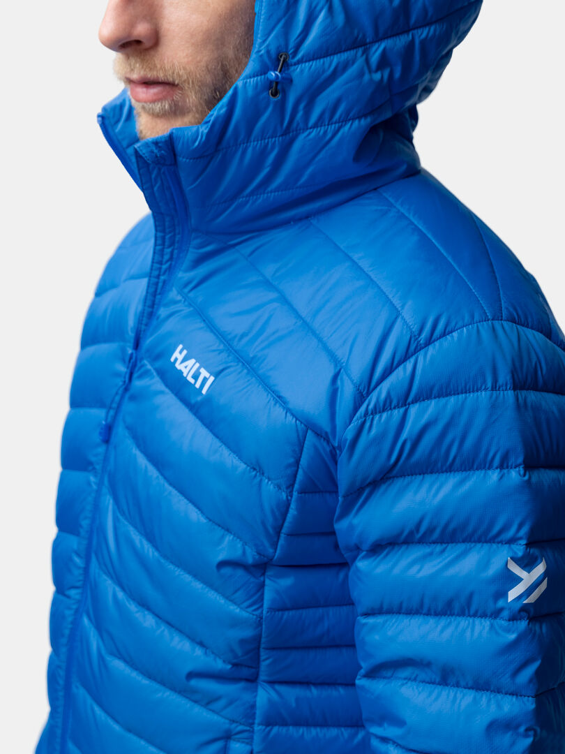 A man wears the Halti Huippu Down Jacket Men’s in bright blue, chest up, against a plain background.