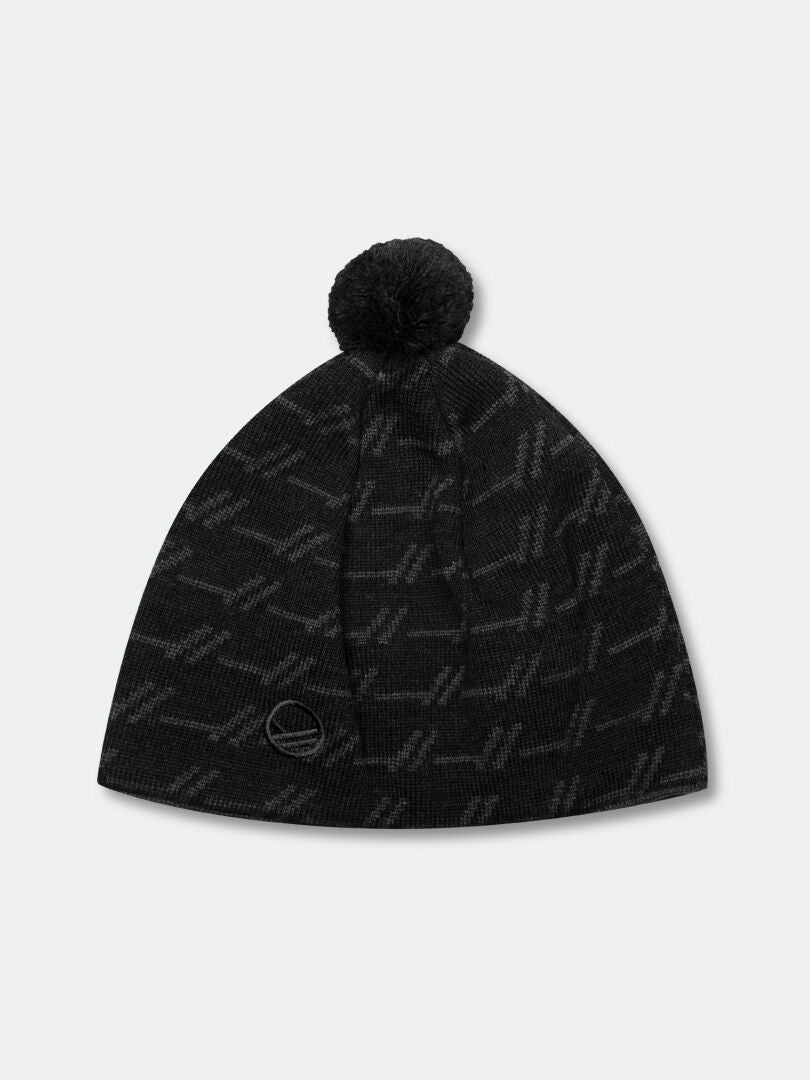 The Halti Ramsau Beanie is a black wool blend with a pom-pom, geometric pattern, and round patch near the brim.