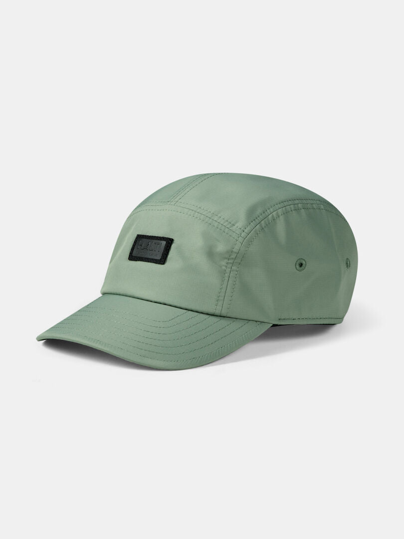 The Halti Staffas Cap is a light green unisex cap with five panels, curved brim, and black rectangular front patch.