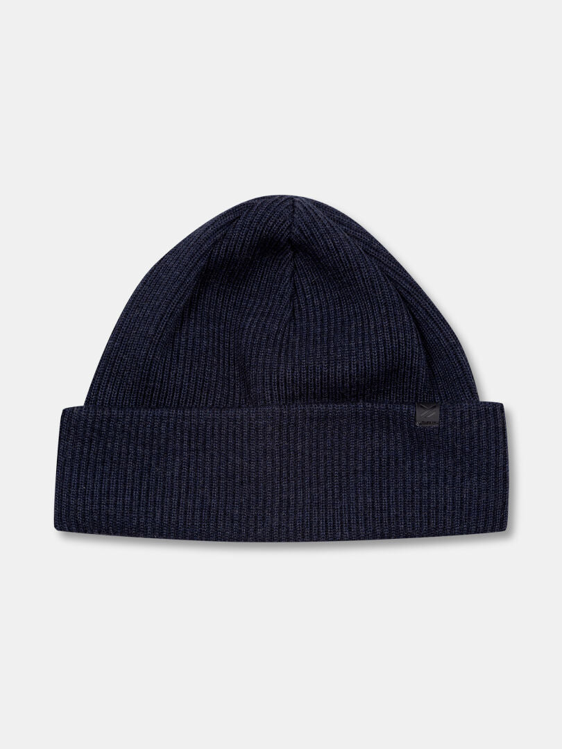 The Halti Pehmee Merino Beanie, dark blue and ribbed, is shown on a light gray background. Made in Finland.