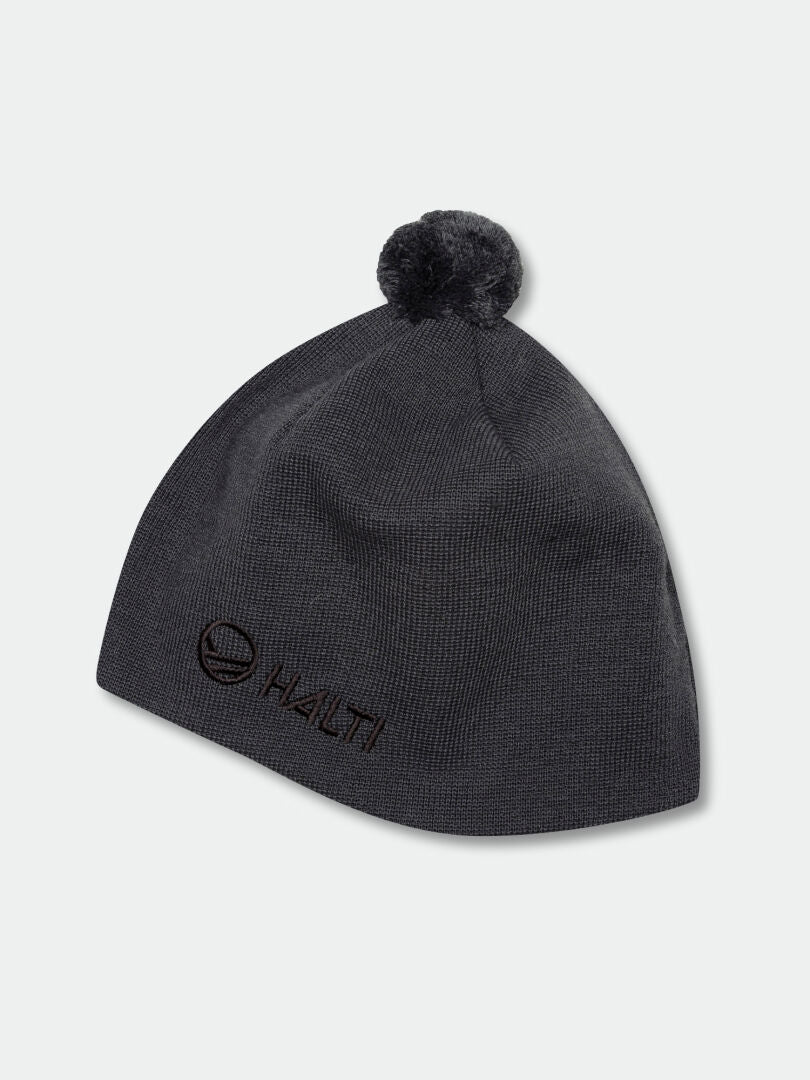 Halti Peesi Beanie: Dark gray knit with windproof Stormwall®, pom-pom, and front Halti logo.