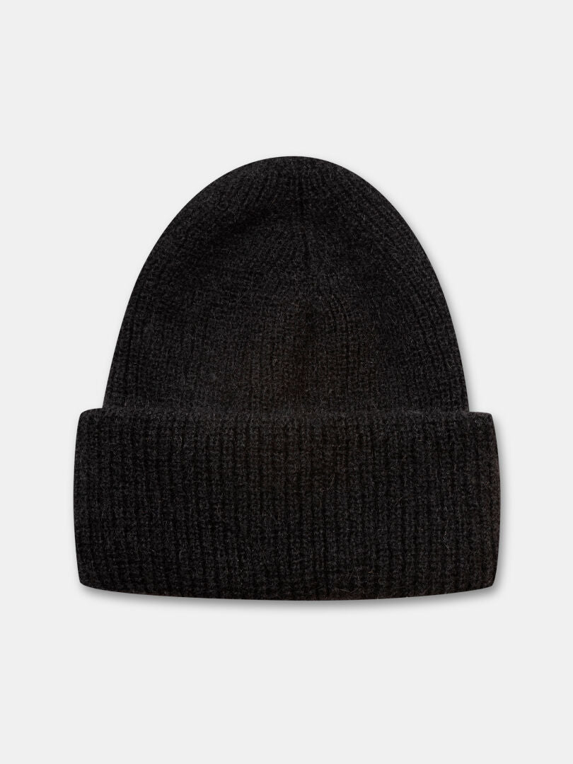 The Halti Vuolle Mohair Beanie is a black merino winter hat with a folded brim, shown on a light gray background.