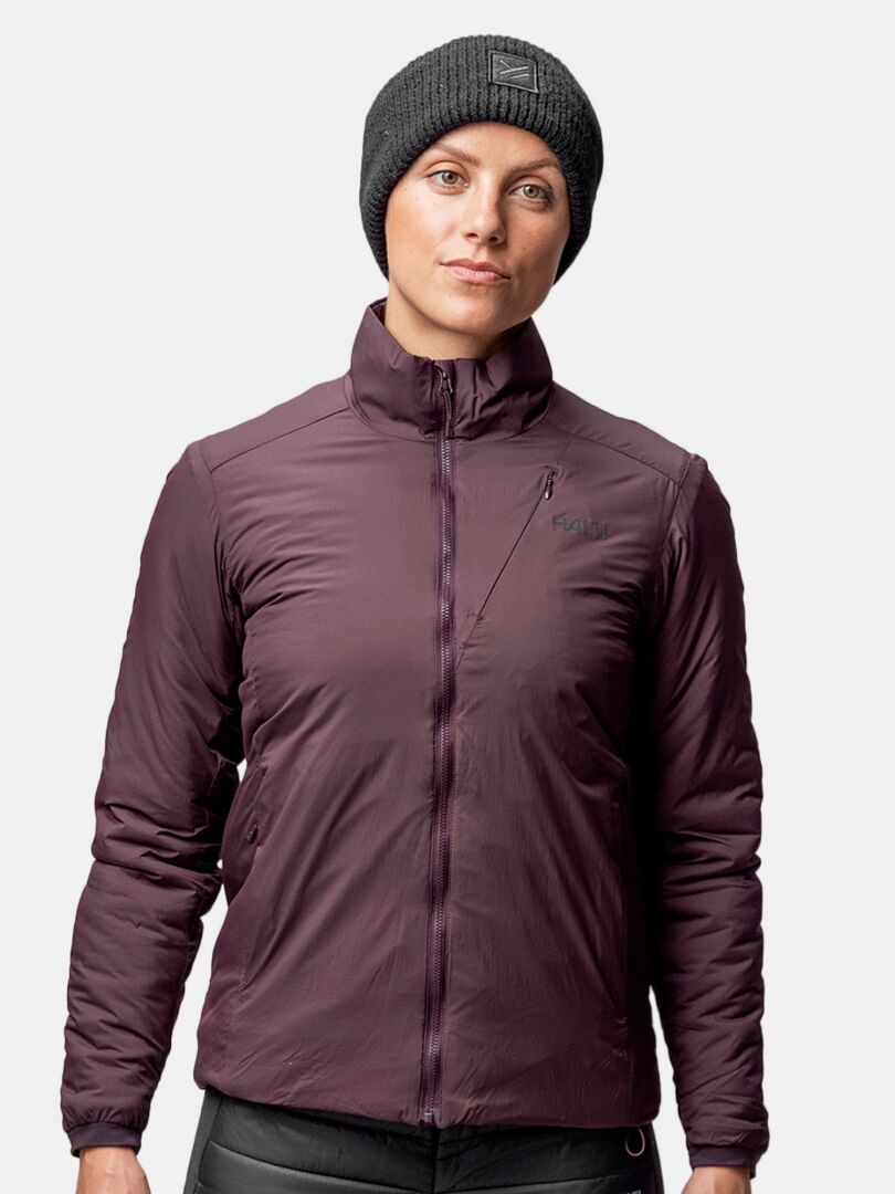 Person wearing a Halti Huurre Headband and a dark purple zip-up jacket, standing against a plain light background.