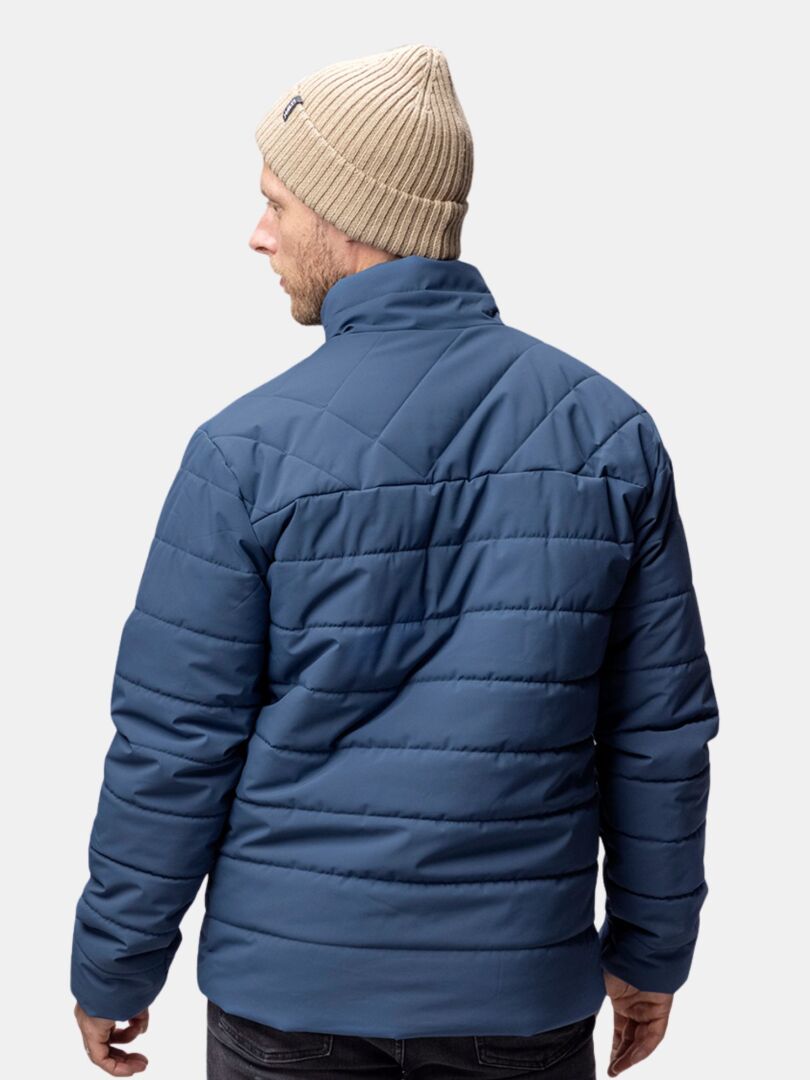 A person in a Halti Runko Beanie and blue quilted jacket is shown from behind, glancing over their shoulder.
