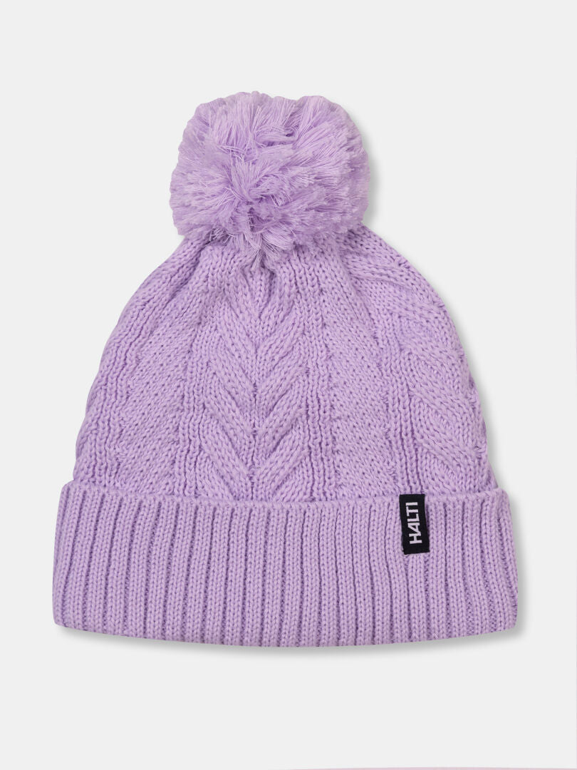 Halti Hile Beanie: light purple cable knit with pom-pom, folded brim, and label—perfect for winter.
