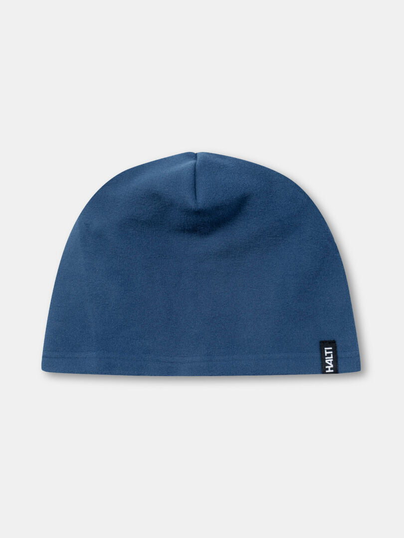The Halti Trone Fleece Beanie, plain blue with a Halti tag on the edge, is shown on a light background.