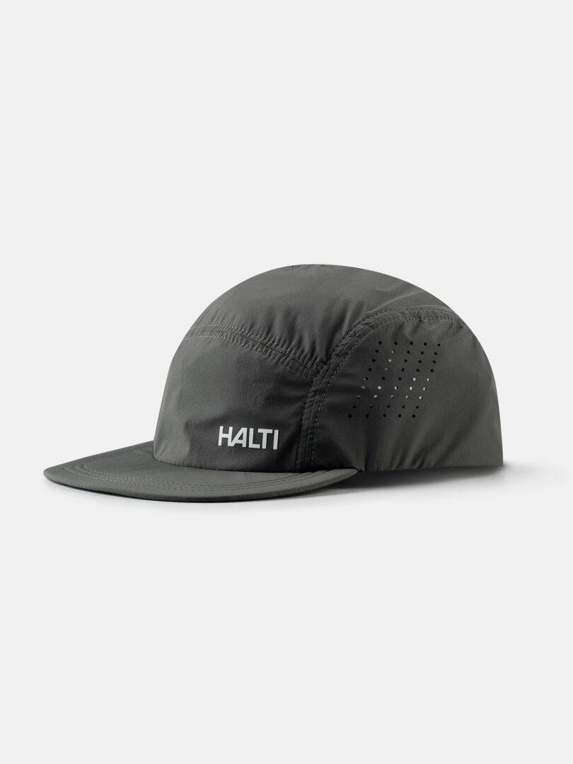 The Halti Luovi Cap is a dark grey running cap with a flat brim and small ventilation holes, shown on a light background.