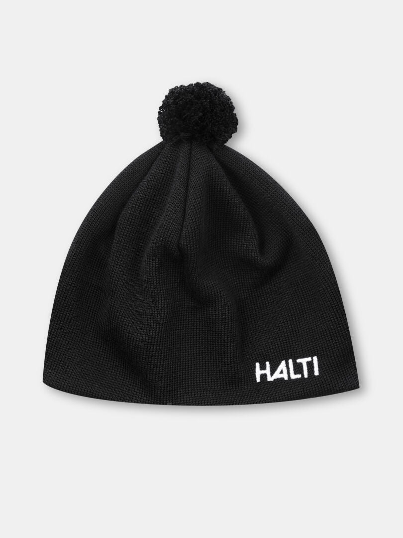 The Halti Peesi II Beanie is a black cross-country ski hat with a pom-pom and white HALTI embroidery on the front.