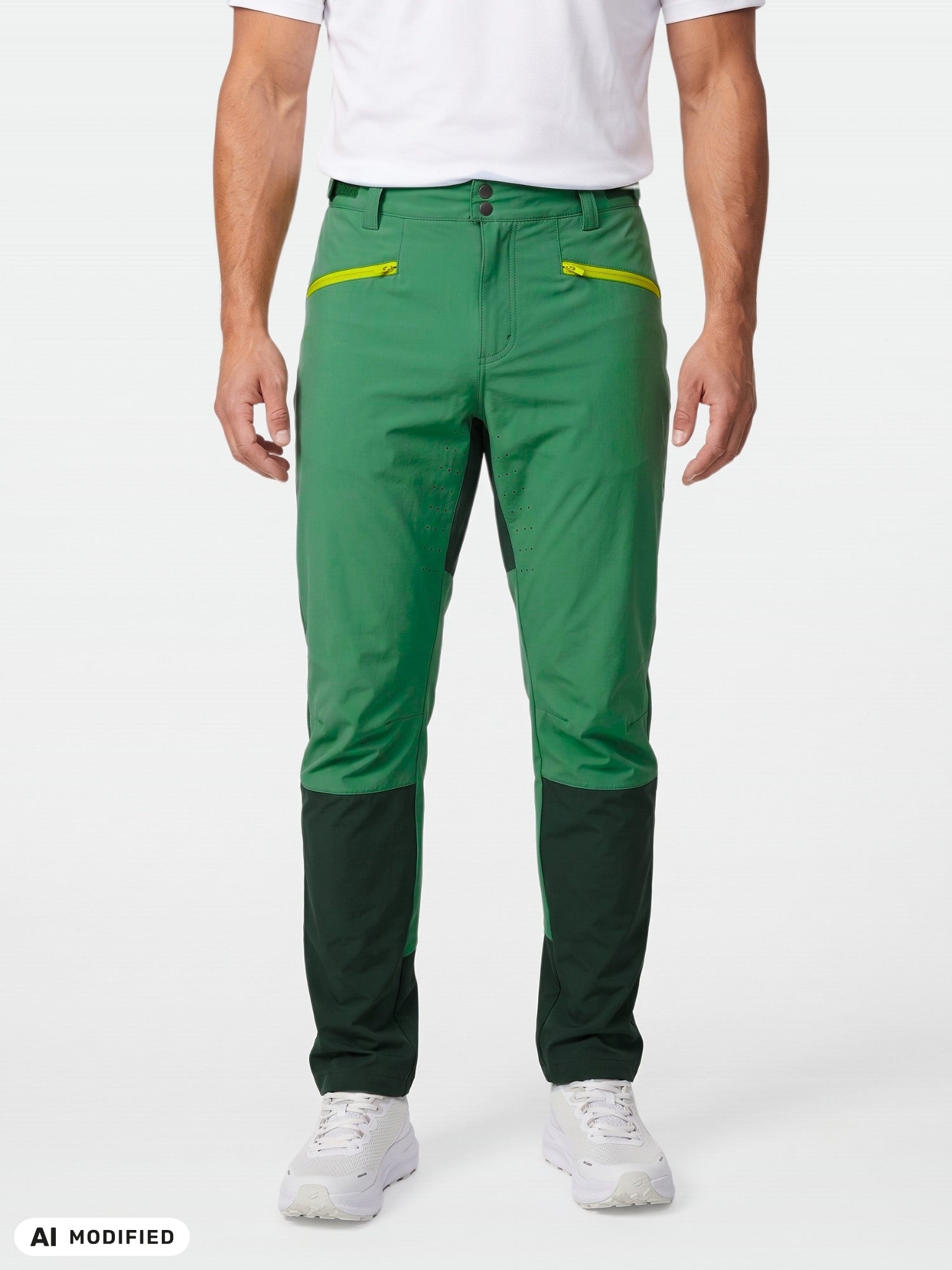 Person wears Halti Tracks X-stretch green pants with dark knee panels, yellow zip pockets, white shoes and shirt.