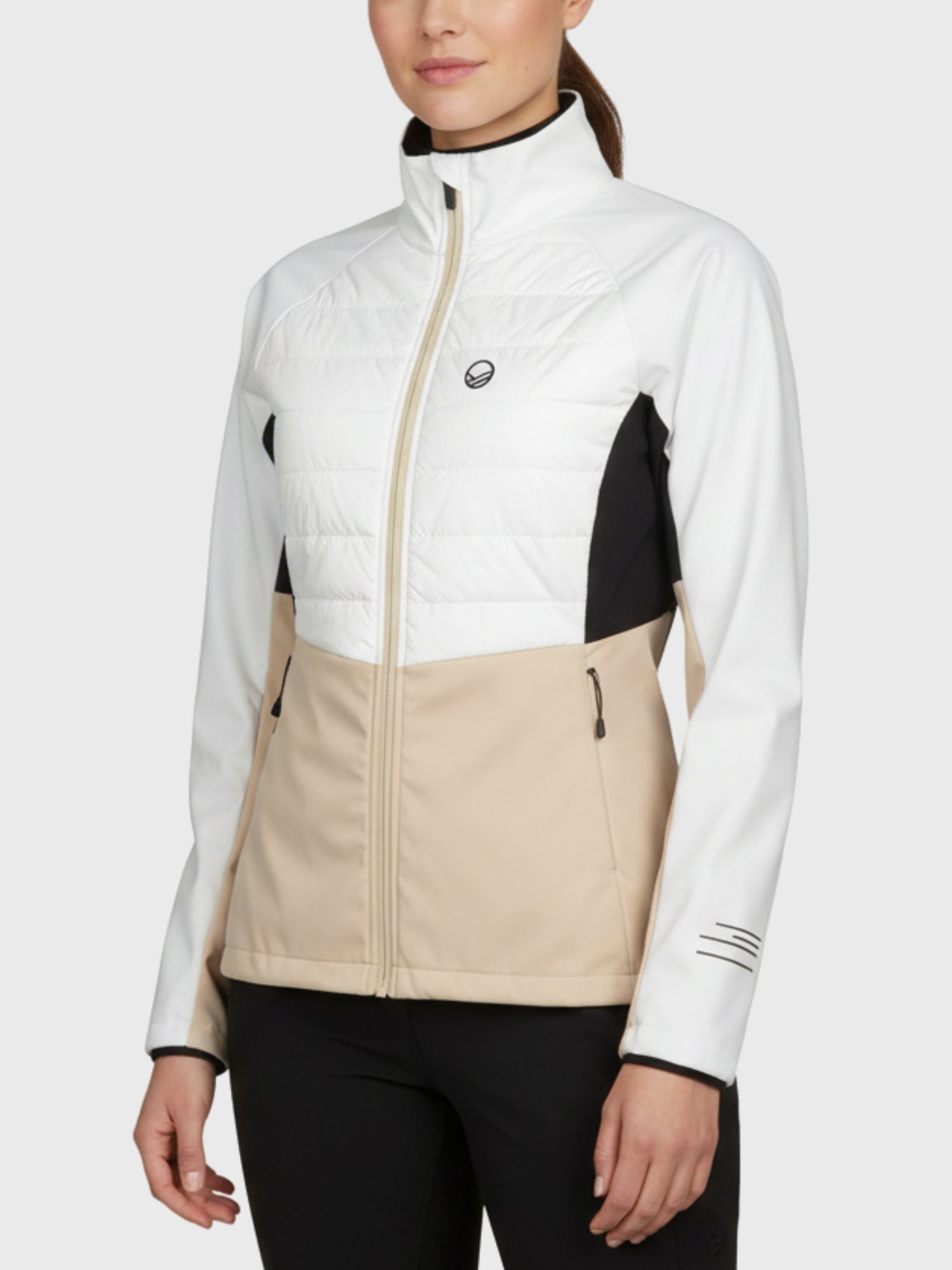 Woman in the Halti Vinha Hybrid XCT Jacket and black pants—ideal for winter running or cross-country skiing.