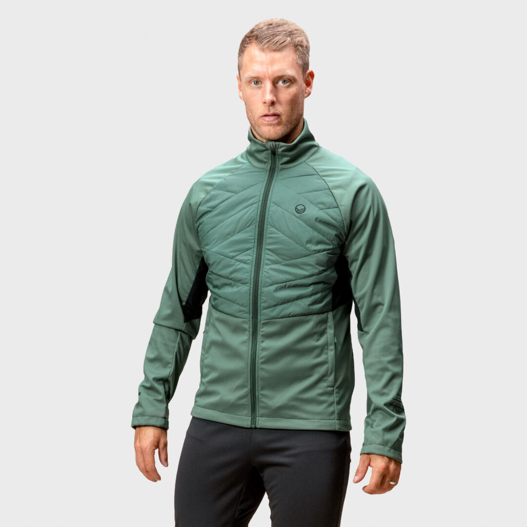 Man wearing Halti Vinha Hybrid XCT Jacket, ideal for winter running, stands against a light gray background.