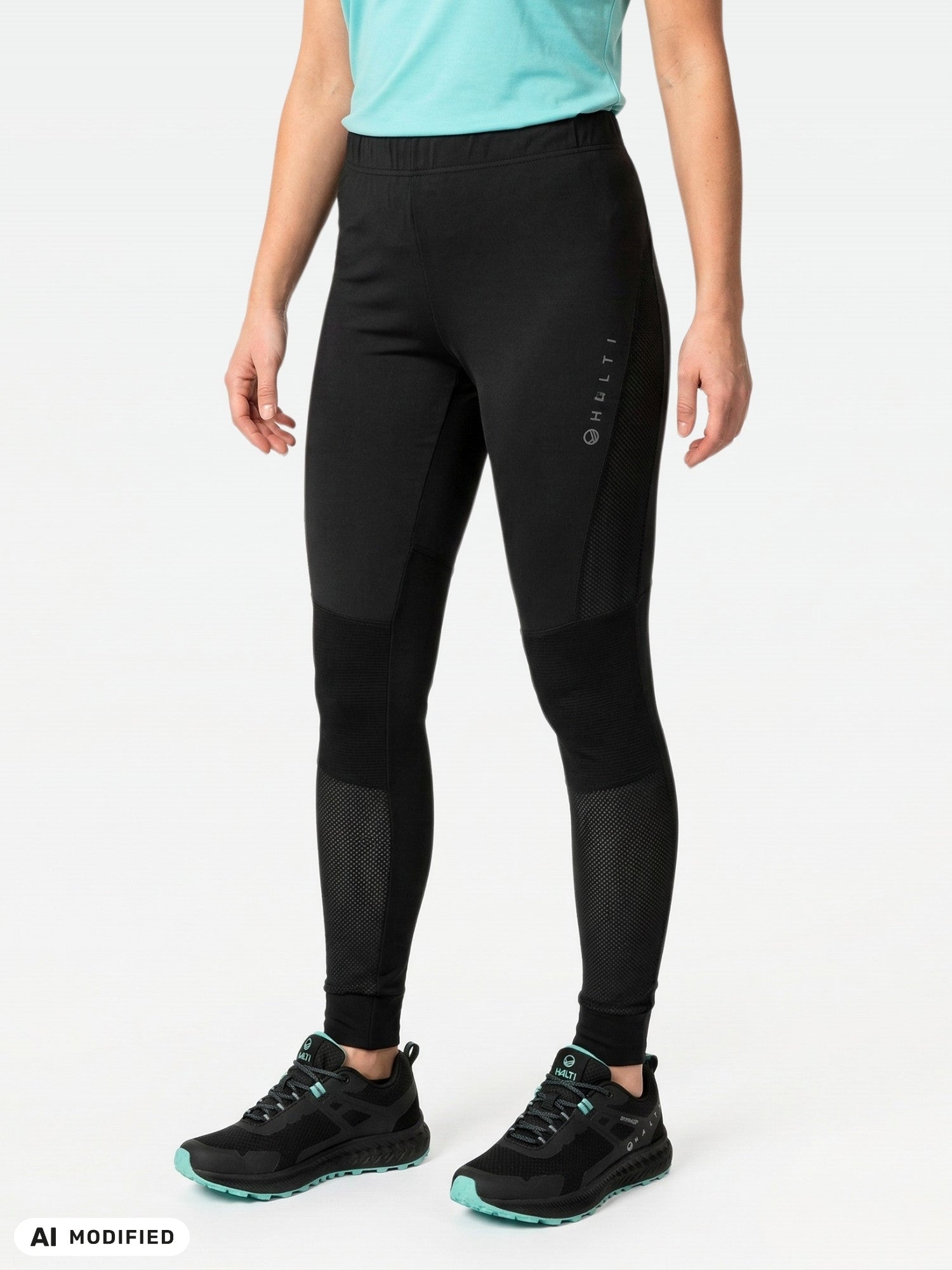 Halti Tracks Seamless Tights Women's in black with mesh panels, logo on thigh, plus black and teal athletic shoes.
