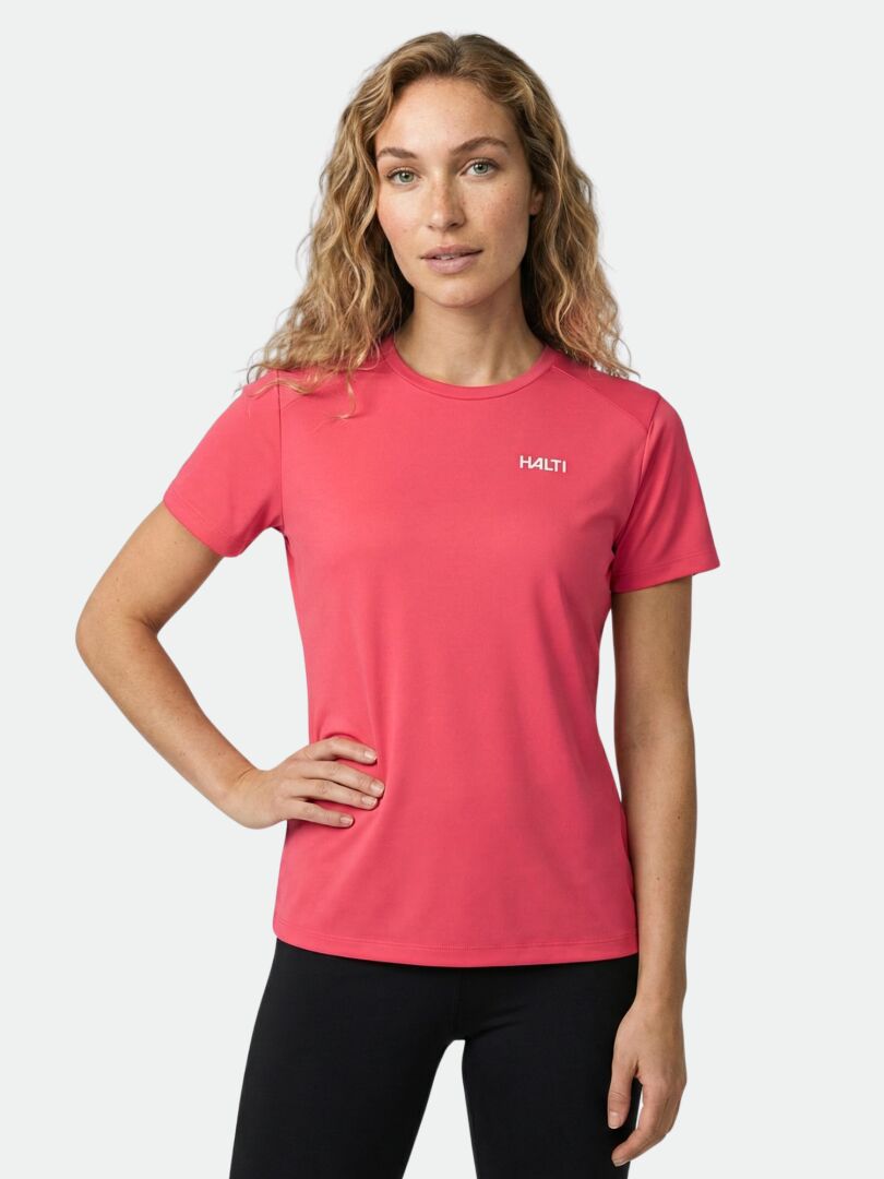 A person faces forward wearing a Halti Salves T-Shirt Women's in pink and black pants against a light background.