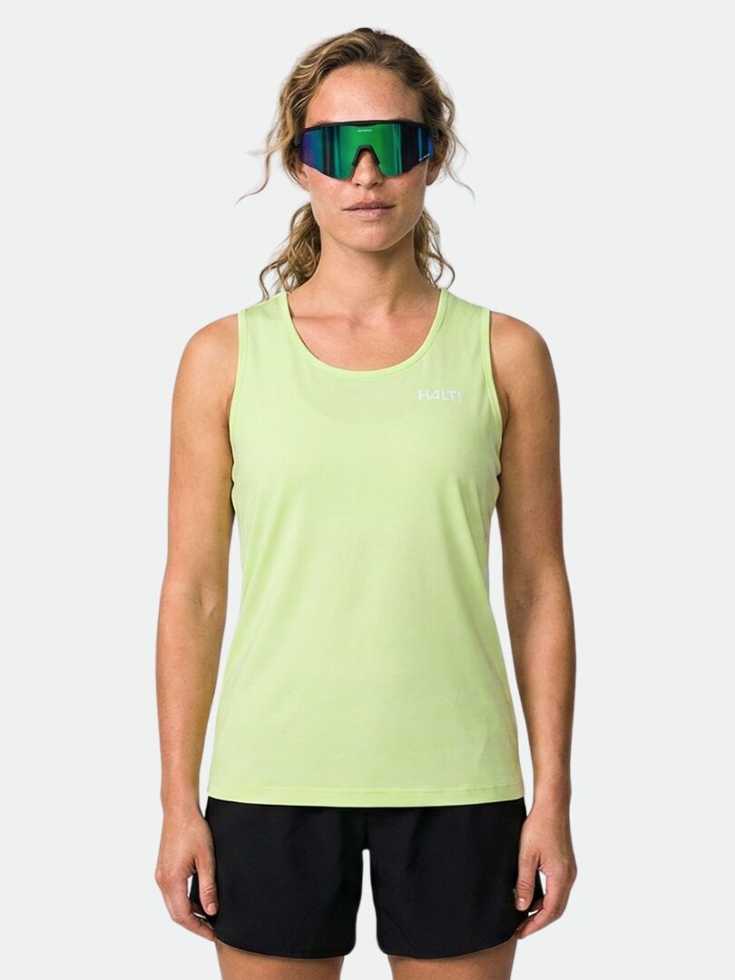 Woman wearing a Halti Salves Top Women's tank, black shorts, and reflective sunglasses against a plain background.