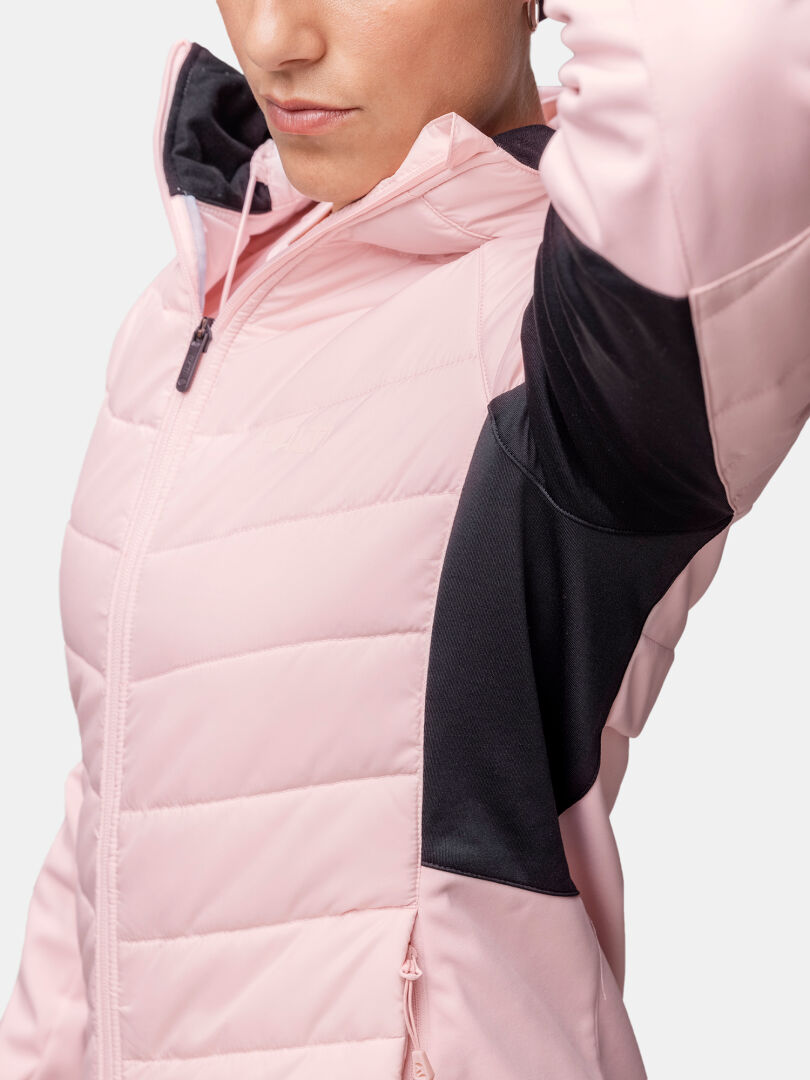 Close-up of a person wearing the Halti Hanki 2 Hybrid XCT Jacket Women's with black panels, against a plain background.