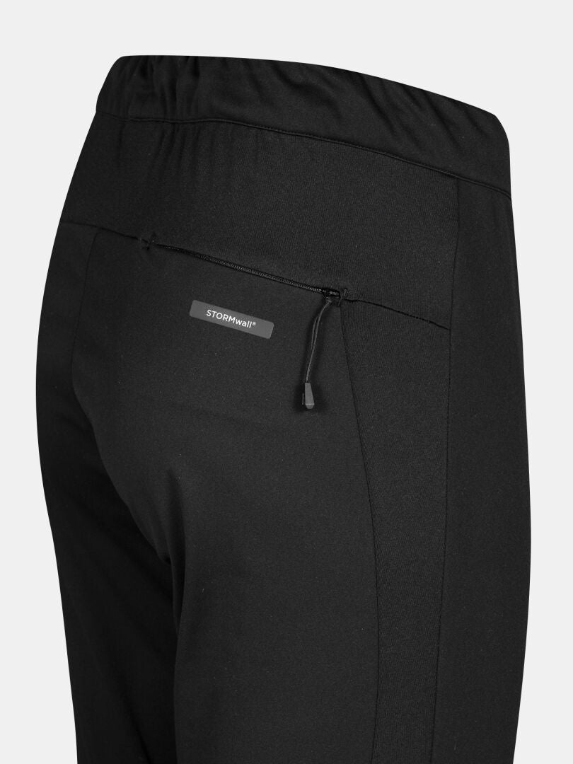 Close-up of Halti Framover XCT Tights Women's: black, windproof, with elastic waistband and STORMwall zip pocket.