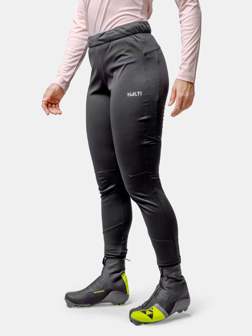 Person wears Halti Framover XCT Tights, black athletic pants, gray boots, and a pink long-sleeve top.
