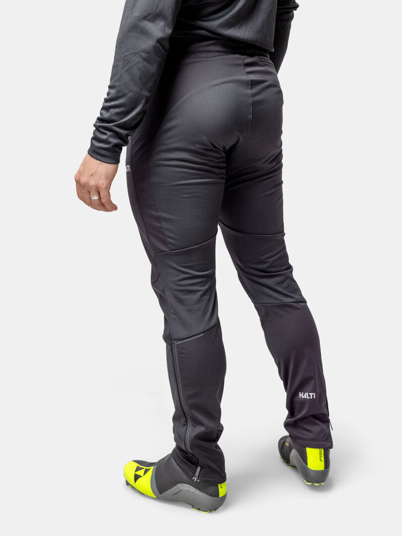 Person wearing Halti Framover XCT Pants and gray top, paired with bright yellow and gray cycling shoes.