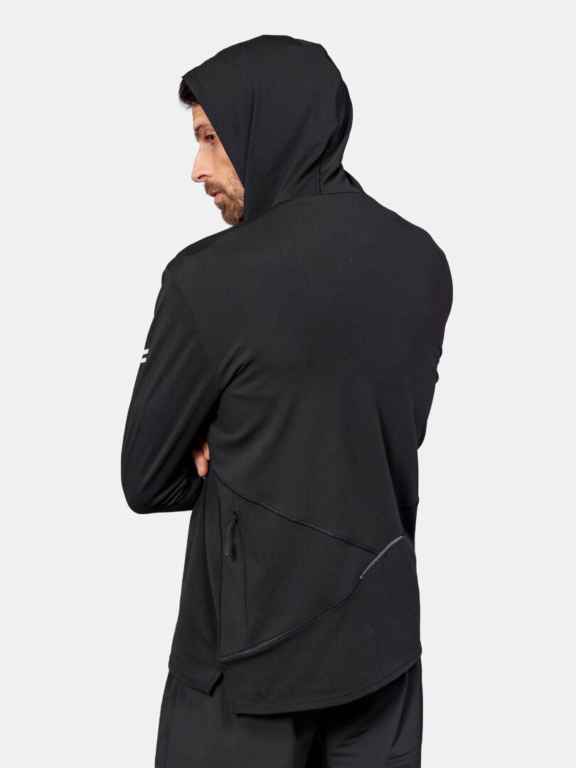 A man wears the Halti Kaltio Training Hoodie Men's, standing with arms crossed, facing away from the camera.