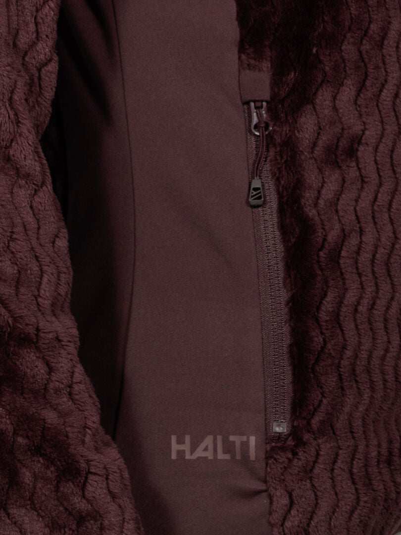 Close-up of Halti Thermel Layer Jacket Womens in maroon with zipper pocket and HALTI logo near the zipper.